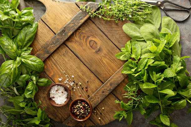 Assorted fresh herbs and spices Assorted fresh herbs and spices on a wooden board, cooking background fresh cilantro stock pictures, royalty-free photos & images