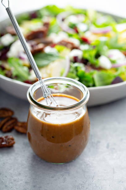 Balsamic vinaigrette dressing Balsamic vinaigrette dressing for a salad, small glass jar with a whisk mustard fruits stock pictures, royalty-free photos & images