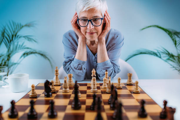 istock Senior Woman Playing Chess. Cognitive Rehabilitation Therapy. 1325964313
