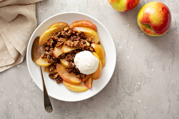 Healthy gluten free apple crisp Healthy gluten free apple crisp or crumble with cinnamon and pecans topped with a scoop of ice cream ice pie photography stock pictures, royalty-free photos & images