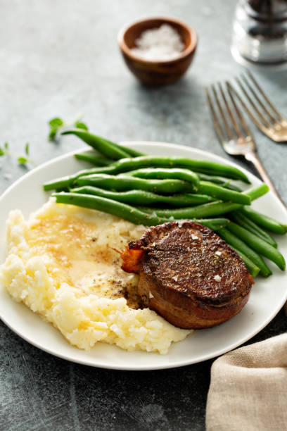 istock Traditional dinner meal with a bacon wrapped steak and potatoes 1325964391