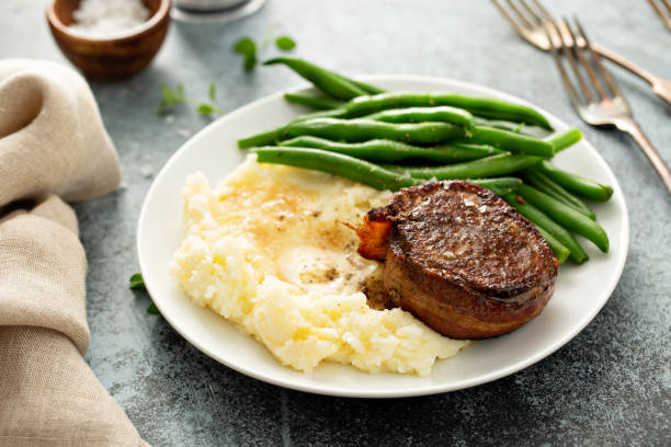 istock Traditional dinner meal with a bacon wrapped steak and potatoes 1325964393