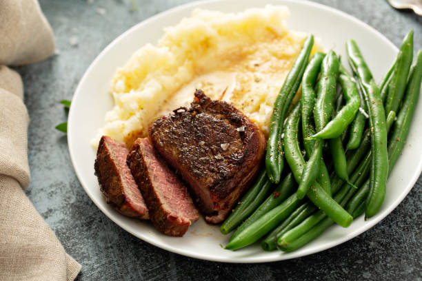 istock Traditional dinner meal with a bacon wrapped steak and potatoes 1325964395