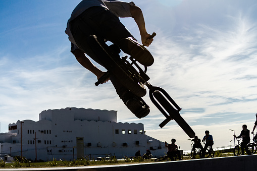 Buenos Aires, Argentina - May 10, 2014: Young man does a trick bike jump on a skatepark