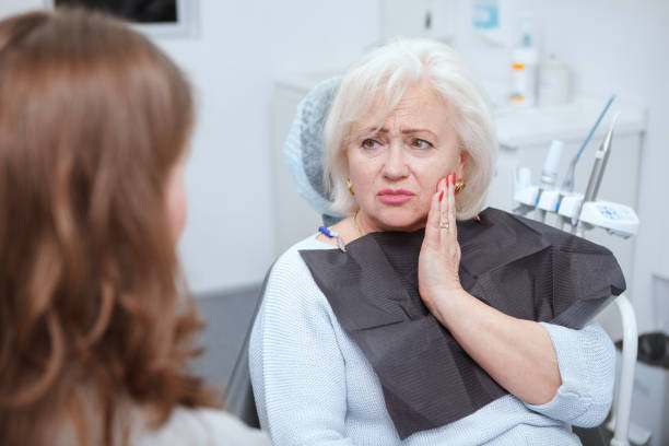 Senior woman at dental clinic Elderly woman suffering from toothache, visiting dentist toothache stock pictures, royalty-free photos & images