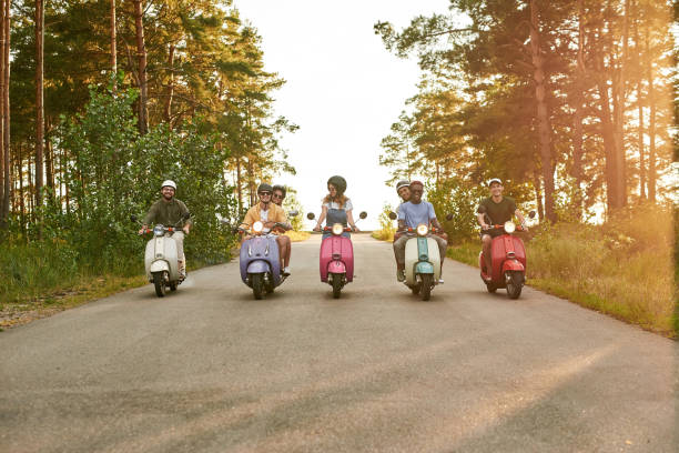 istock Cheerful young multiracial people riding colorful scooters 1325967801