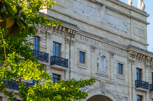 Banco de Santander Bank headquarter building in Paseo Pereda. Neoclassical palace. Arch