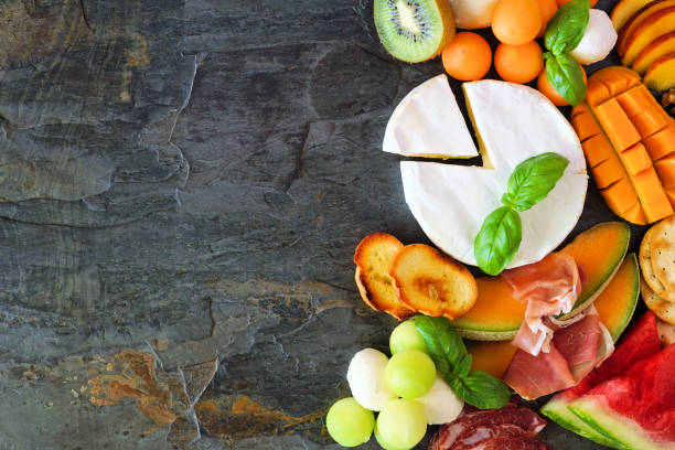 Summer fruit theme charcuterie side border against a dark slate background