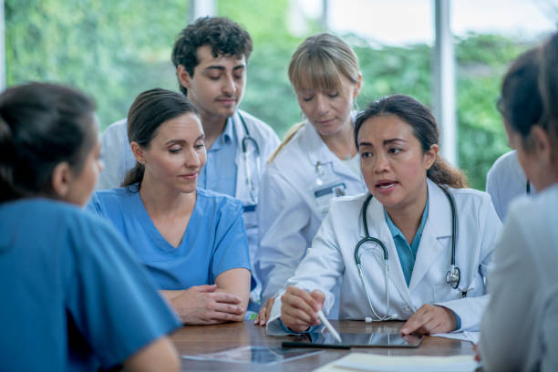 istock Group of medical professionals discuss 1325973881