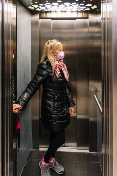 istock Senior Woman in Elevator 1325981948