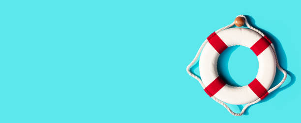 istock Lifebuoy on blue background. Copy space 1325984050