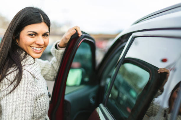 Millennial Female Entering and Exiting a Car Photo Series In Western Colorado Millennial Female Entering and Exiting a Car Photo Series Matching 4K Video Available (Shot with Canon 5DS 50.6mp photos professionally retouched - Lightroom / Photoshop - original size 5792 x 8688 downsampled as needed for clarity and select focus used for dramatic effect) car city urban scene commuter stock pictures, royalty-free photos & images