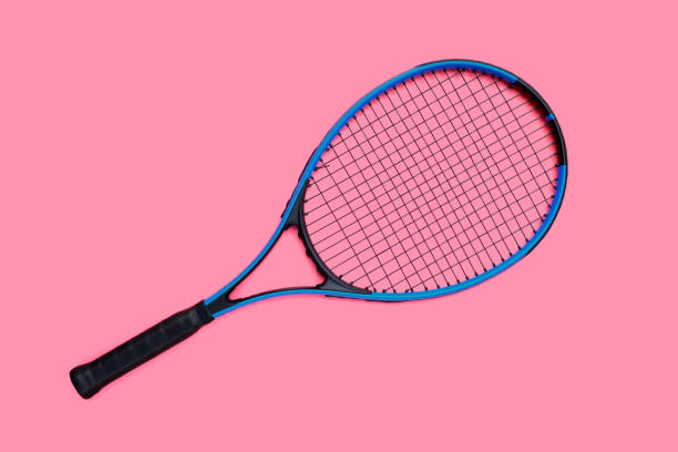 istock Tennis racket on pink background. 1325985084