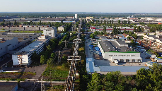 Industrial Zone. Aerial top view of the large logistics park with factories, plants, thermoelectric power station, garages, hangars in the city. Aerial view industrial buildings architecture from top.
