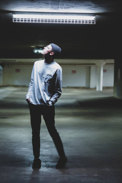 istock creative flash photography of a man in a parking garage under a luminescent light 1325987832