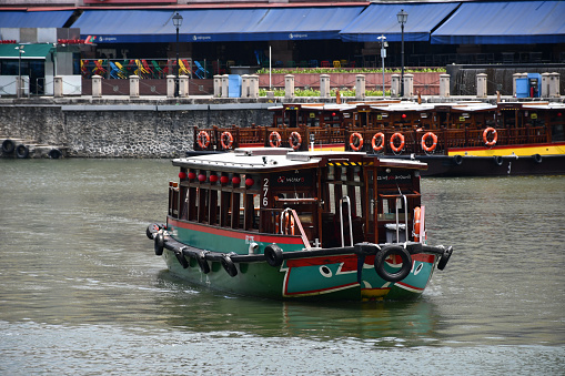 Singapore, Singapore - August 22, 2019: A river cruise boat (a bumboat operated by Water B) on the Singapore River.