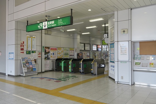 Sano Station gates and name board in the station in Sano, Tochigi, Japan. June 24, 2021