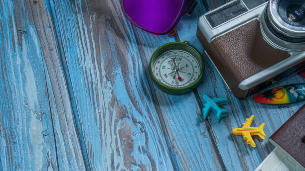 istock camera and passport on wood table for travel concept. 1325993431
