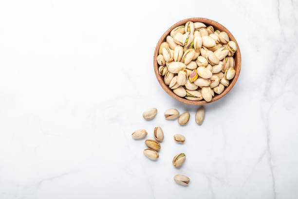 istock pistachios nuts in wooden bowl 1325997505