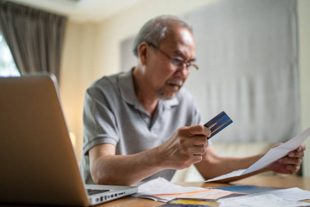istock Depressed desperate Asian Senior Elderly male feeling worried about financial problem. Stressed older man looking frustrated to paperwork and bills think of money debt, budget loss, bankruptcy at home 1326002819