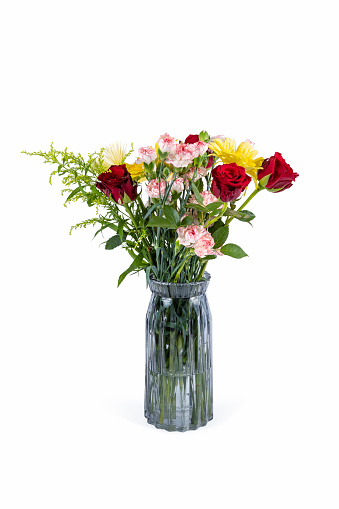 glass vase with bouquet of beautiful fresh flowers against white background