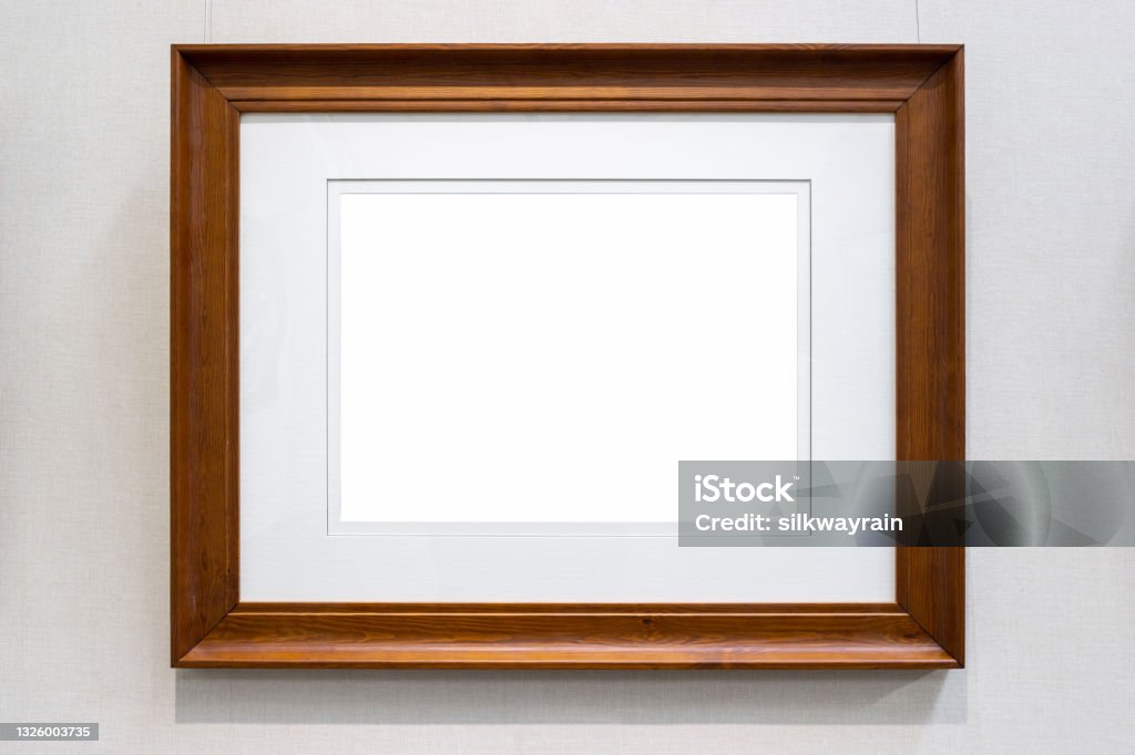 single brown wooden picture frame single brown wooden picture frame with wall cloth background, clipping path included Picture Frame Stock Photo