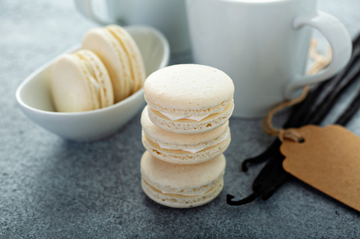 Vanilla macarons stacked with coffee and vanilla pods, french dessert