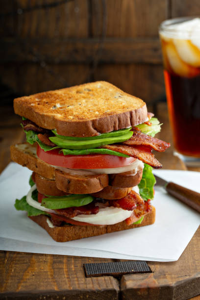 istock Avocado BLT sandwiches on wooden surface 1326004595