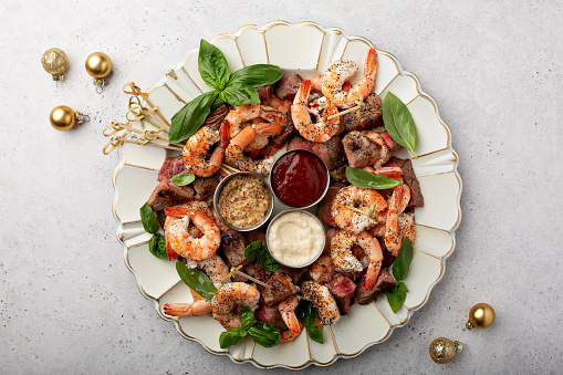 Christmas or New Year party appetizer, shrimp and steak with dipping sauces overhead