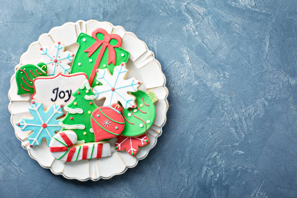 Christmas sugar and gingerbread cookies Christmas sugar and gingerbread cookies decorated with royal icing on a plate overhead white sugar cookie stock pictures, royalty-free photos & images