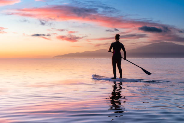 istock Adventurous girl on a paddle board is paddeling in the Pacific West Coast Ocean 1326004804