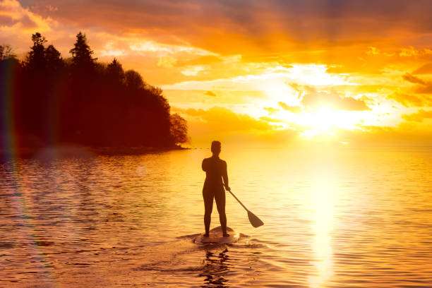 istock Adventurous girl on a paddle board is paddeling in the Pacific West Coast Ocean 1326004826