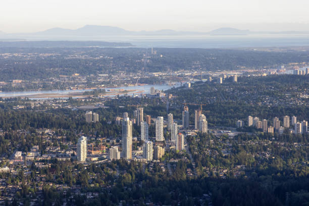 Aerial View from Airplane of Residential Homes and Buildings in a modern city Aerial View from Airplane of Residential Homes and Buildings in a modern city during sunny evening. Taken in Coquitlam, British Columbia, Canada. new westminster stock pictures, royalty-free photos & images