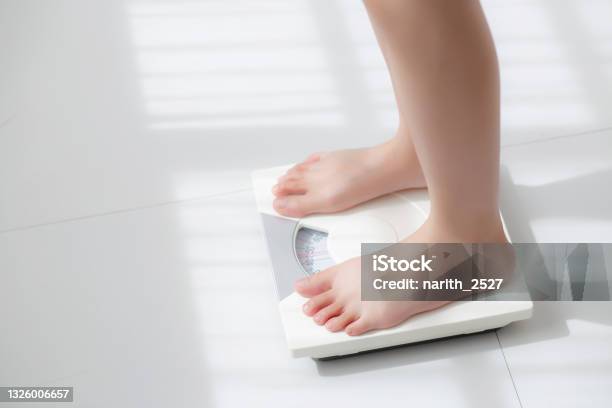 Lifestyle Activity With Leg Of Woman Stand Measuring Weight Scale For Diet With Barefoot Closeup Foot Of Girl Slim Weight Loss Measure For Food Control And Nutrition Healthy Care And Wellness Concept Stock Photo - Download Image Now