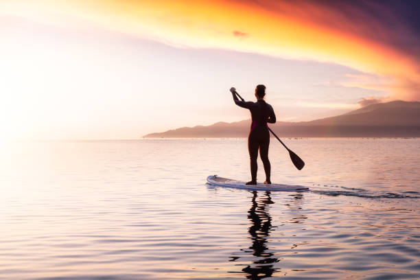 istock Adventurous girl on a paddle board is paddeling in the Pacific West Coast Ocean 1326007377