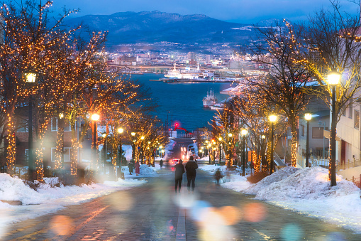 Hachimanzaka famous romantic road destination of tourist and traveller on winter. On night with city and bokeh background. Hakodate, Hokkaido, Japan.