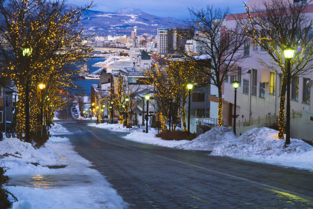 Hachimanzaka famous romantic destination of tourist and traveller on winter. Hachimanzaka famous romantic destination of tourist and traveller on winter. On sunset with city background. Hakodate, Hokkaido, Japan. motomachi kobe stock pictures, royalty-free photos & images