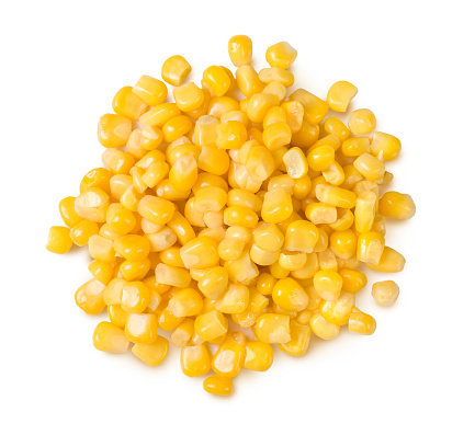A pile of corn seeds isolated on white background. Top view.