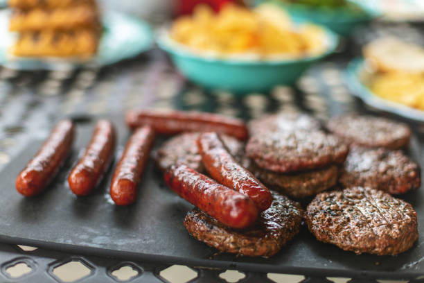 beef burgers and bratwurst bangers outdoor bbq grilled western colorado cooking photo series - red meat meat dish grilled rare imagens e fotografias de stock