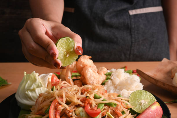 Cropped shot woman making spicy papaya salad. Cropped shot woman making spicy papaya salad. tam o'shanter stock pictures, royalty-free photos & images