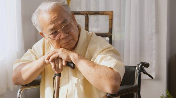 istock Pensive disabled elderly patient sit on wheelchair alone 1326023361