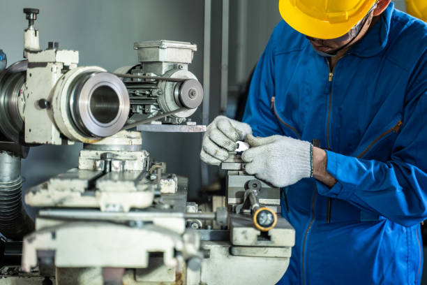 istock Asian attractive mechanical workman wear protective glasses and helmet for safety, work on milling machine in Industrial factory. Industry Technician worker male check and control at the steel machine 1326023964