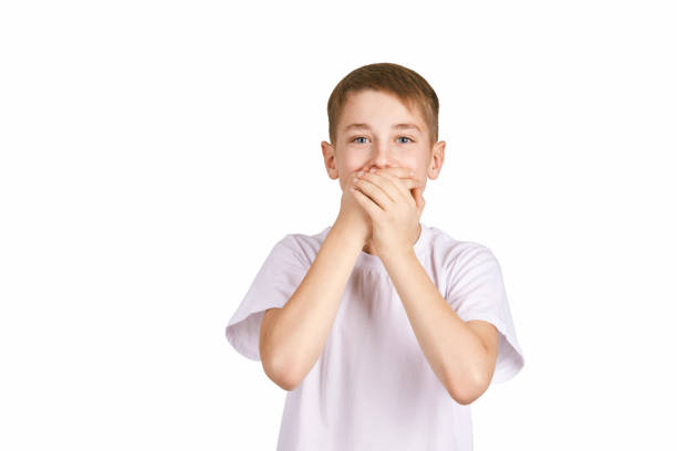 children portrait in white t-shirt. studio isolated concept - facial expression unpleasant smell shirt caucasian imagens e fotografias de stock