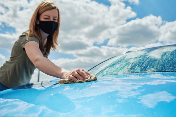 istock Hand cleaning modern blue car with microfiber cloth 1326024566