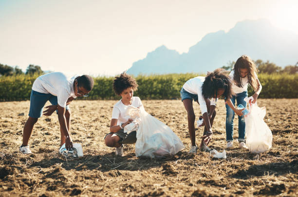 plan d’un groupe d’adolescents ramassant des déchets sur un terrain au camp d’été - pollution free photos et images de collection