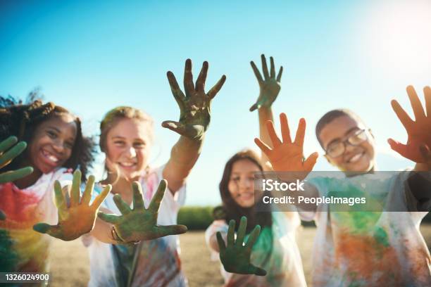 Shot Of A Group Of Teenagers Having Fun With Colourful Powder At Summer Camp Stock Photo - Download Image Now