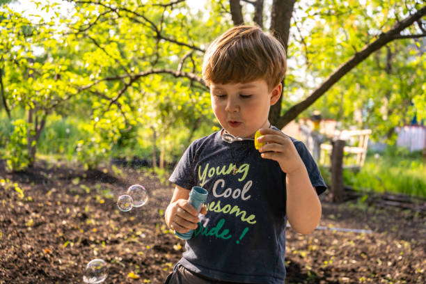 istock Little four years boy blow soap bubbles, outdoors, summer, happy boy 1326025917