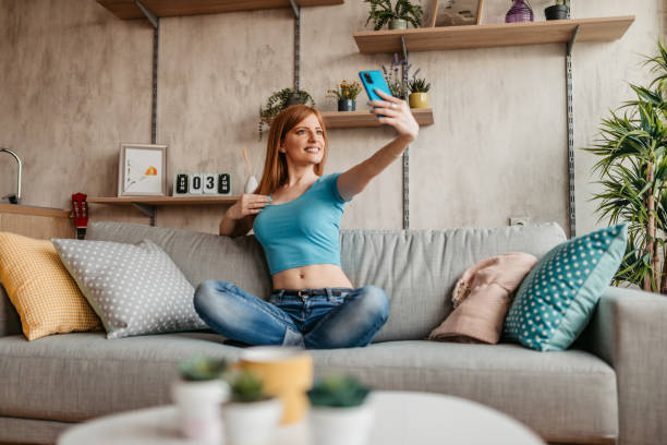 istock Woman having video call with her friend using smart phone 1326025977