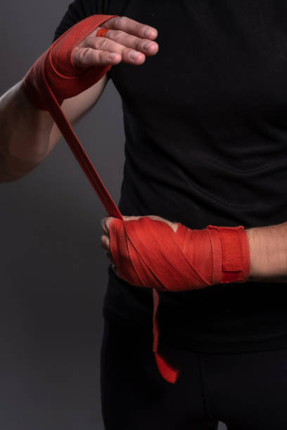 istock Male hands wrapped with red boxing tape before fight 1326026172