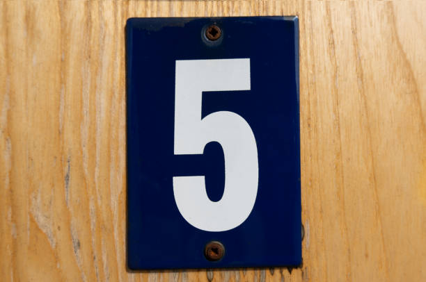 old blue enamel sign with white number 5 stock photo